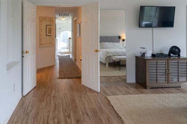 Bedroom with wood finished floors and baseboards | Image 29