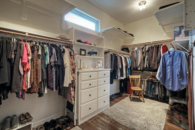 Spacious closet with dark wood-type flooring | Image 21