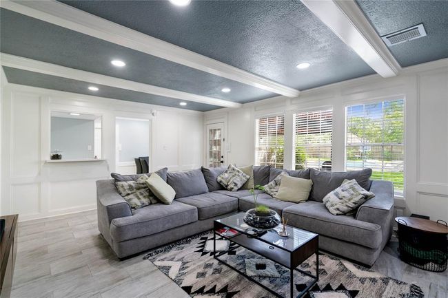 Living room with view of the pool and serve-through in the kitchen | Image 6