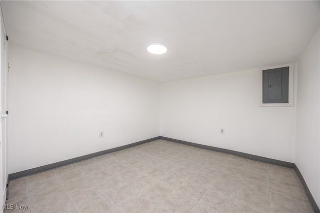 Spare room featuring electric panel and baseboards | Image 24