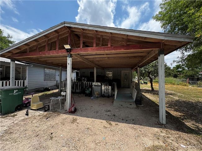 View of parking / parking lot featuring a carport | Image 4
