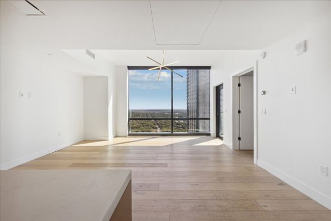 Unfurnished dining area featuring light wood-style flooring and expansive windows | Image 7