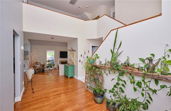 Hallway featuring light hardwood / wood-style flooring and a high ceiling | Image 12