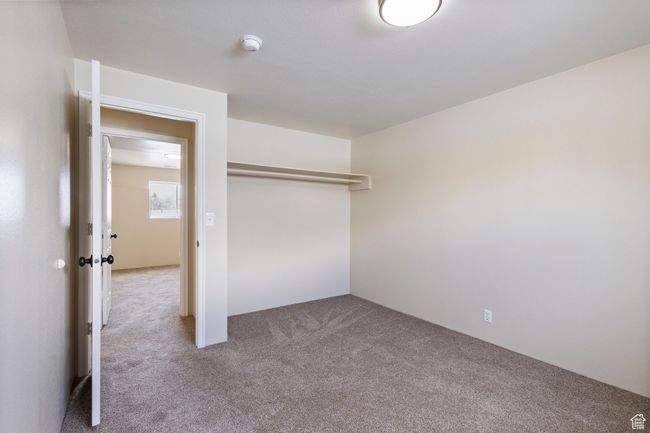 Bedroom 5 with a closet and carpet flooring | Image 26
