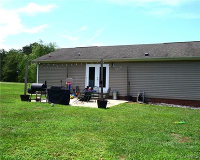 Rear view of house with a yard and a patio | Image 3