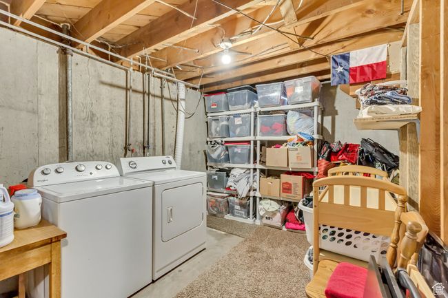 Clothes washing area featuring washer and clothes dryer and laundry area | Image 18