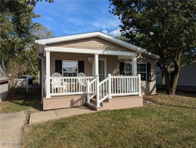 Bungalow with a front yard and a porch | Image 2