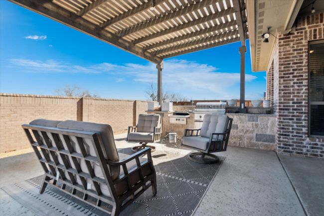 View of patio / terrace featuring fence, an outdoor kitchen, a grill, and a pergola | Image 24