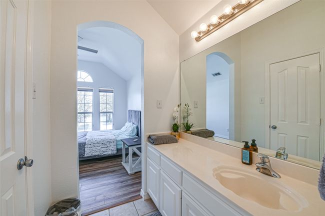 Bathroom featuring lofted ceiling, vanity, and hardwood / wood-style floors | Image 18
