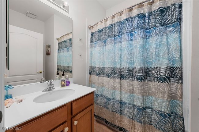 Full bath featuring vanity, curtained shower, and visible vents | Image 21