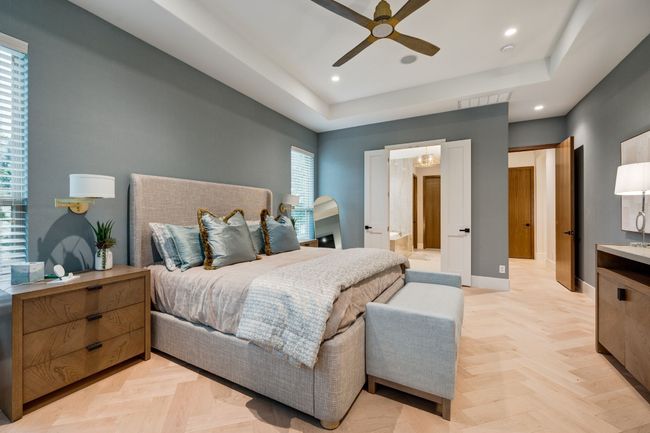 Bedroom with recessed lighting, a tray ceiling, baseboards, a ceiling fan, and ensuite bathroom | Image 15
