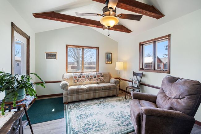 The sunroom has views of the backyard and open vista | Image 13