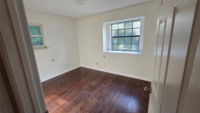 Unfurnished room featuring dark wood-type flooring and baseboards | Image 22