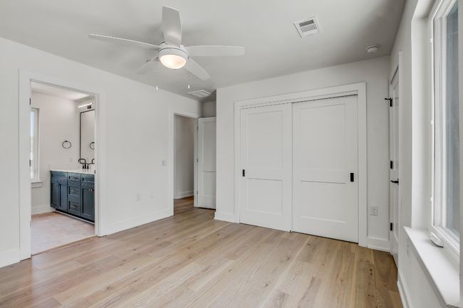 Unfurnished bedroom featuring light wood-style flooring, a closet, connected bathroom, and a sink | Image 19