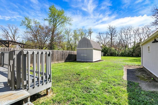 view of yard with a wooden deck, an outbuilding, a shed, and a fenced backyard | Image 41