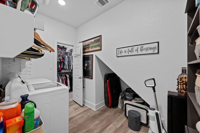 The laundry room opens to one of the primary bedroom closets for easy access. | Image 30