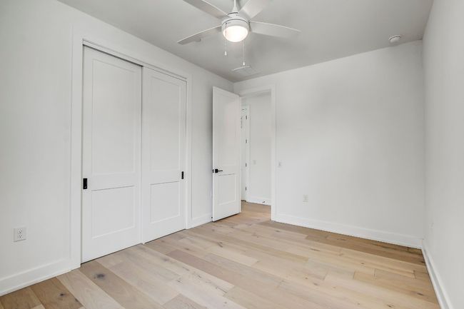Unfurnished bedroom with light wood-style flooring, baseboards, a closet, and a ceiling fan | Image 21