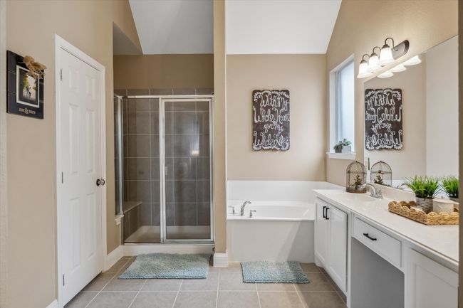 Bathroom featuring a garden tub, a shower stall, vanity, and tile patterned floors | Image 19