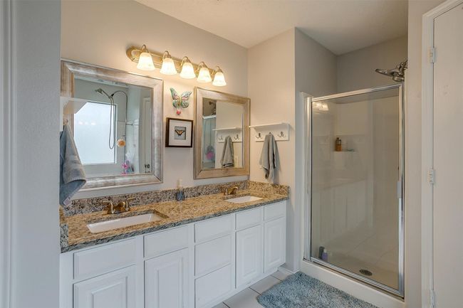 Bathroom with a stall shower, tile patterned floors, and double vanity | Image 30