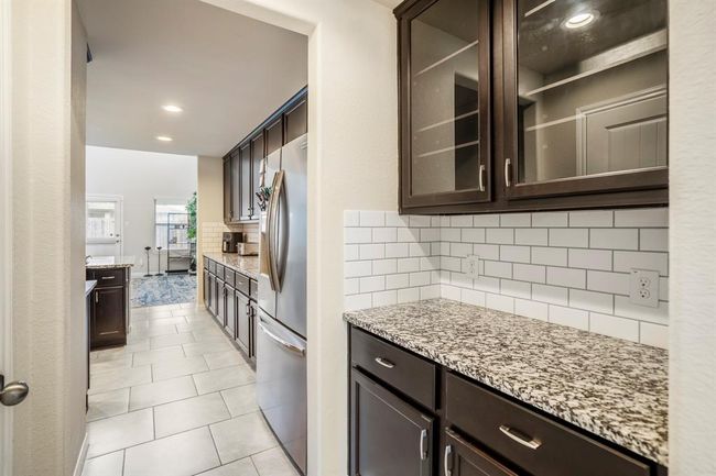 A wonderful feature is the beverage station with granite countertops and lots of additional storage. | Image 6