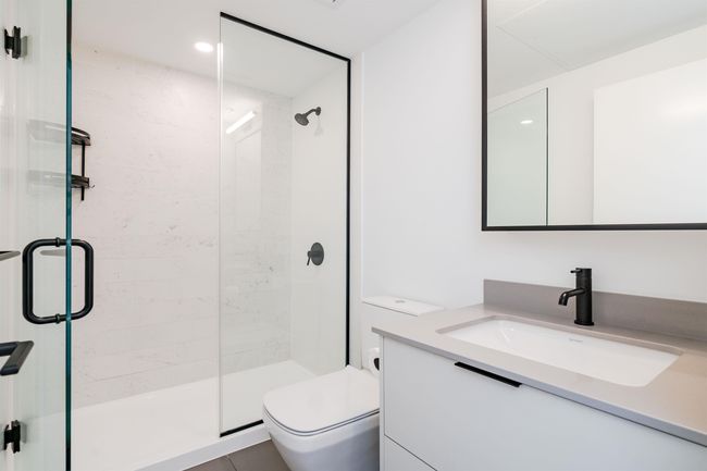 Bathroom featuring toilet, a shower stall, and vanity | Image 26