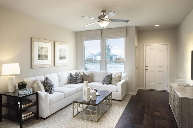 Living room featuring a ceiling fan, baseboards, and wood finished floors | Image 36