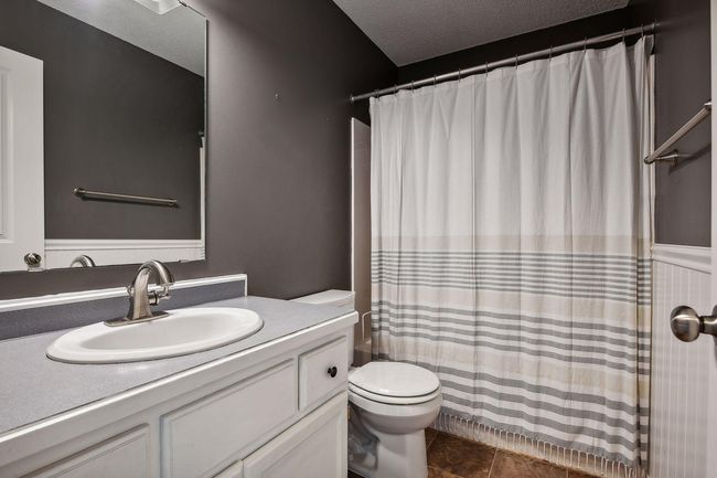 This room also has a ceiling fan and white woodwork | Image 22