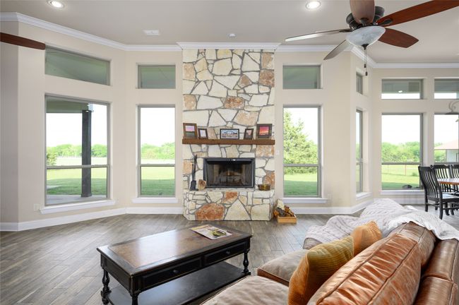 Living area with baseboards, crown molding, and plenty of natural light | Image 9
