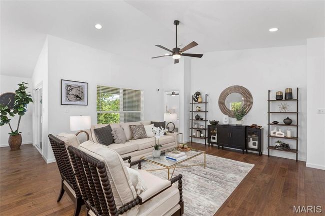 Living room featuring ceiling fan, hardwood / wood-style floors, recessed lighting, baseboards, and high vaulted ceiling | Image 10