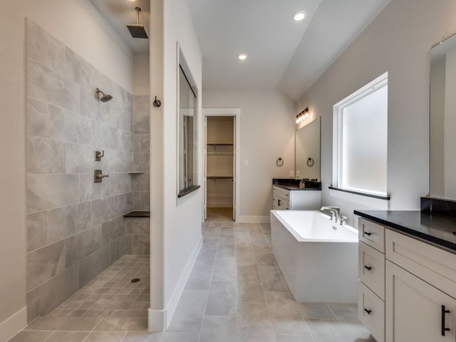 This oversized owner's walk in shower complete with multiple shower heads and built in bench seat is the perfect place to start or end your day! | Image 14