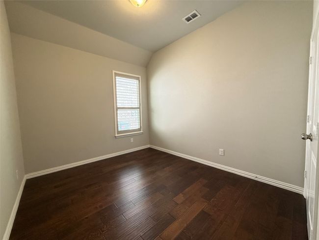 Unfurnished room with dark wood finished floors, baseboards, and vaulted ceiling | Image 12