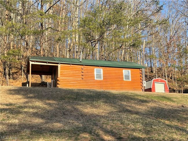 View of outdoor structure with a yard | Image 7