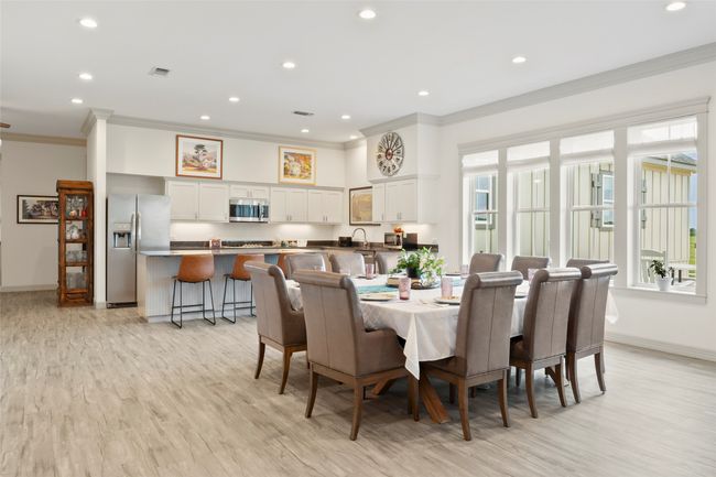 Dining space with light wood-style flooring, visible vents, crown molding, and recessed lighting | Image 9