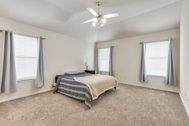 Bedroom featuring carpet flooring and multiple windows | Image 15