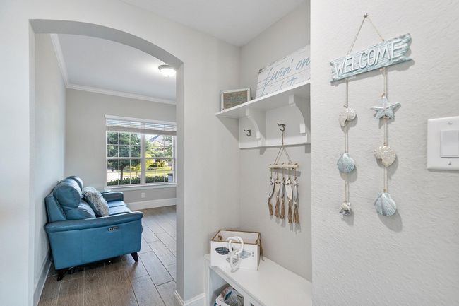 Featuring warm décor with nautical accents, this space flows seamlessly into a bright sleeping area highlighted by a large, sun-filled window. | Image 28