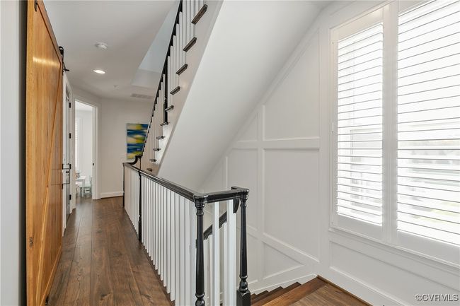 Hall featuring recessed lighting, dark wood finished floors, an upstairs landing, and a decorative wall | Image 27