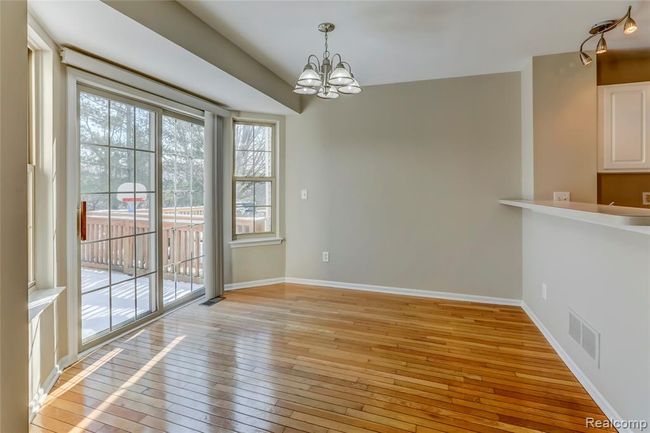 Breakfast nook adjacent to the kitchen featuring a snack bar. | Image 5