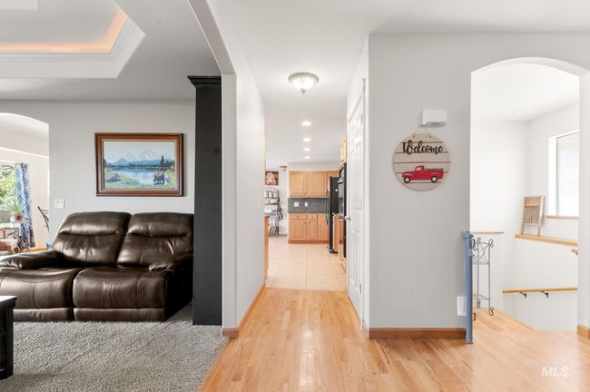 Hall with arched walkways, hardwood finished floors, and recessed lighting | Image 9