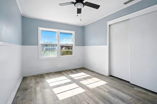 Unfurnished bedroom with wood finished floors, a closet, and a ceiling fan | Image 19