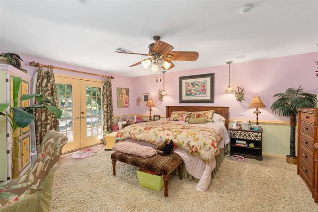Large primary bedroom with french doors to swim spa | Image 21