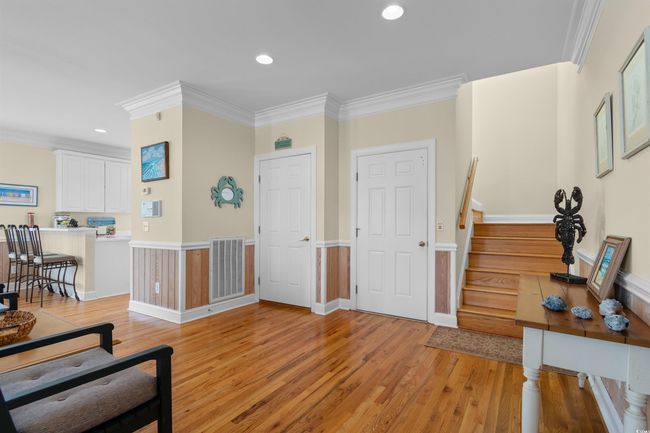 Entrance foyer with light wood-style floors, ornamental molding, stairway, and recessed lighting | Image 27