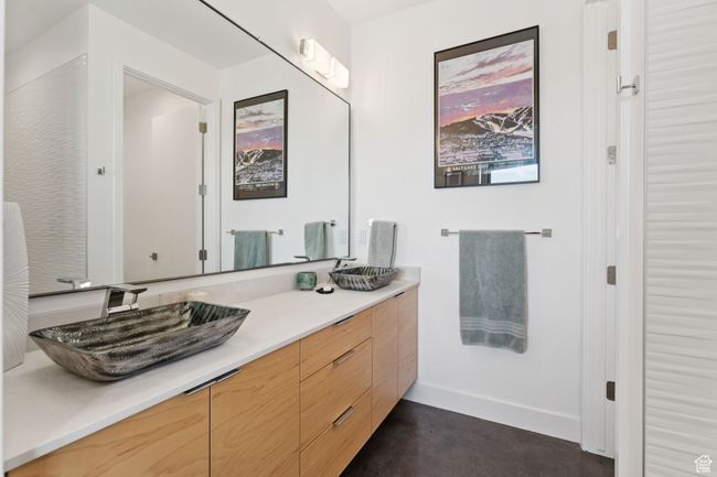 Bathroom with double vanity and baseboards | Image 59