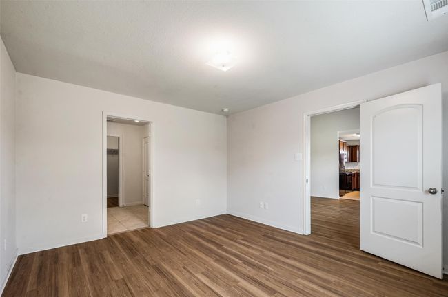 Empty room with wood finished floors and baseboards | Image 11