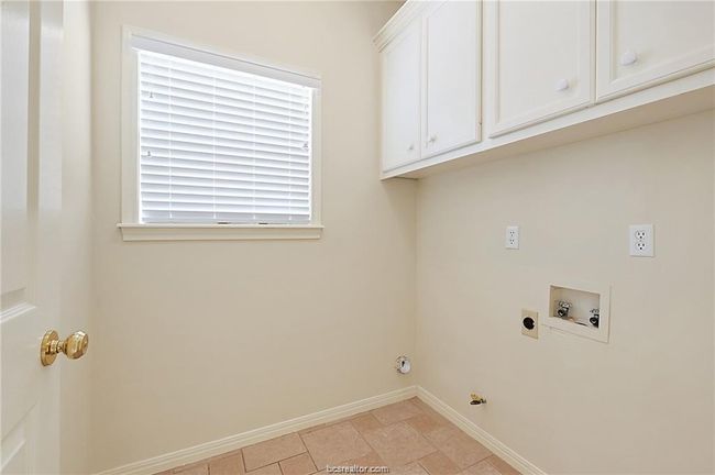 Washroom featuring baseboards, hookup for a washing machine, cabinet space, gas dryer hookup, and hookup for an electric dryer | Image 13