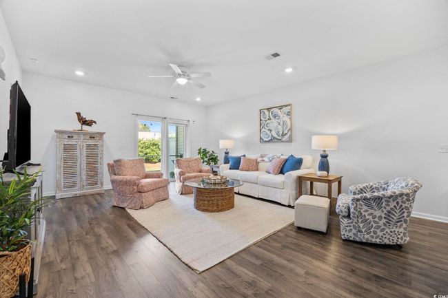 Living room with visible vents, baseboards, recessed lighting, a ceiling fan, and dark wood-style floors | Image 16