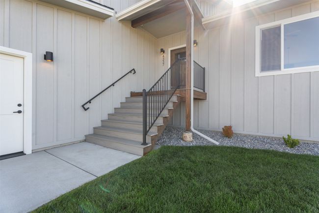 Entrance to property featuring a lawn and board and batten siding | Image 5