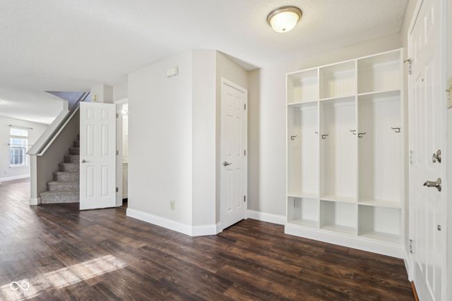 Tucked nicely just inside the front entry area is a place for storing seasonal wear, shoes, carrying bags. There is also an entry storage closet. | Image 11
