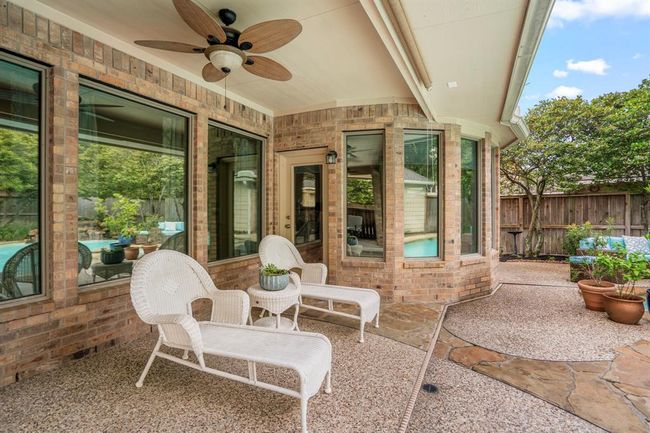 Relax and enjoy a glass of wine while watching the family enjoy cooling off in the sparkling pool. | Image 35