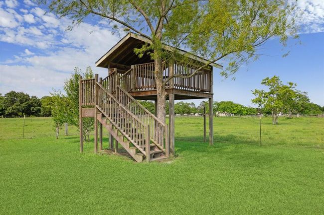 Check out this backyard elevated playhouse, a great spot to enjoy a cup of coffee and watch the sunrise, or take in the views | Image 35