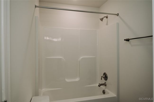 Bathroom featuring bathing tub / shower combination | Image 13